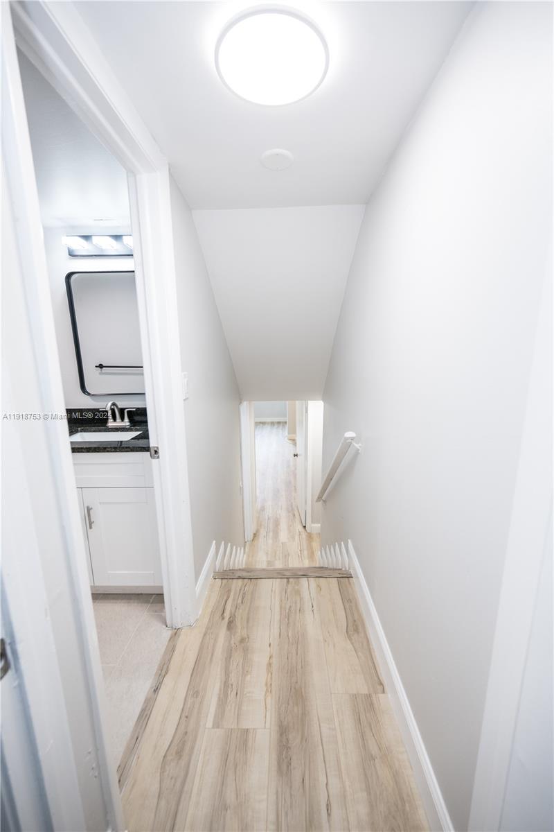 755 Dotterel Road, Unit 1301 Delray Beach, FL 33444 - Photo 13 of 15 a view of kitchen and empty room with wooden floor