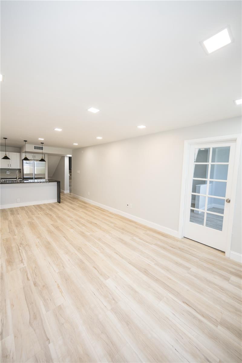 755 Dotterel Road, Unit 1301 Delray Beach, FL 33444 - Photo 14 of 15 a view of an empty room with wooden floor and a window