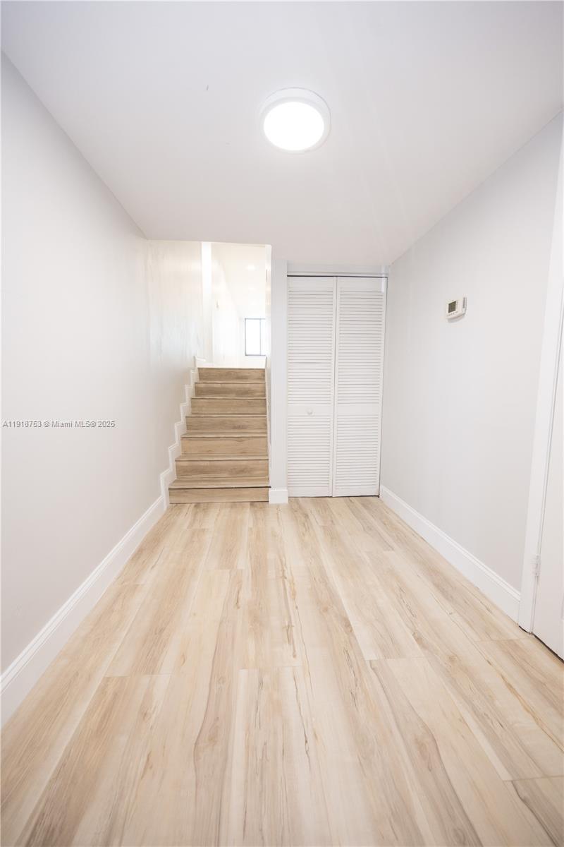 755 Dotterel Road, Unit 1301 Delray Beach, FL 33444 - Photo 2 of 15 a view of empty room with wooden floor