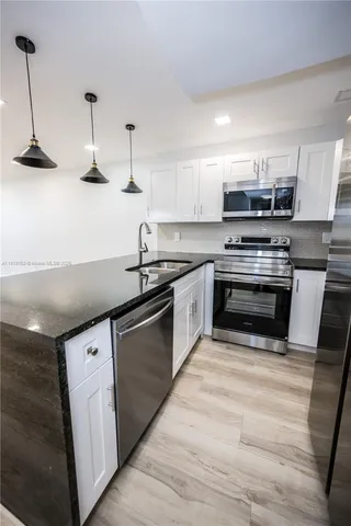 a kitchen with stainless steel appliances and a sink