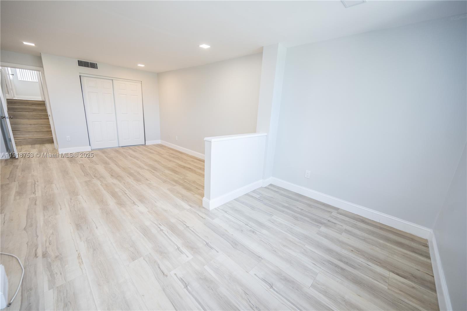 755 Dotterel Road, Unit 1301 Delray Beach, FL 33444 - Photo 8 of 15 a view of an empty room with wooden floor