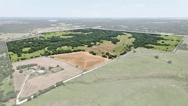 an aerial view of a house with yard