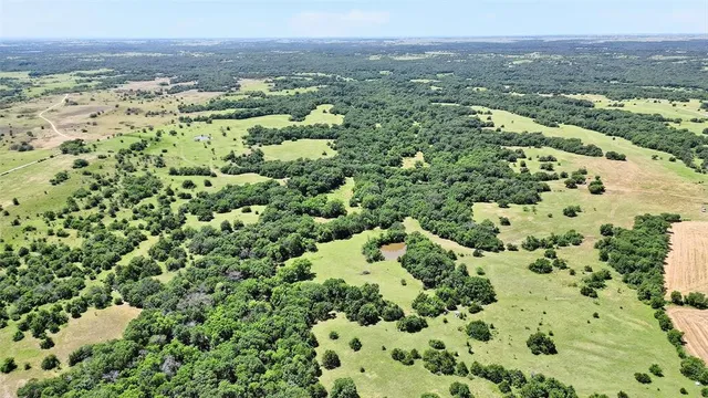 an aerial view of a houses with a yard