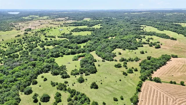 an aerial view of a houses with a yard