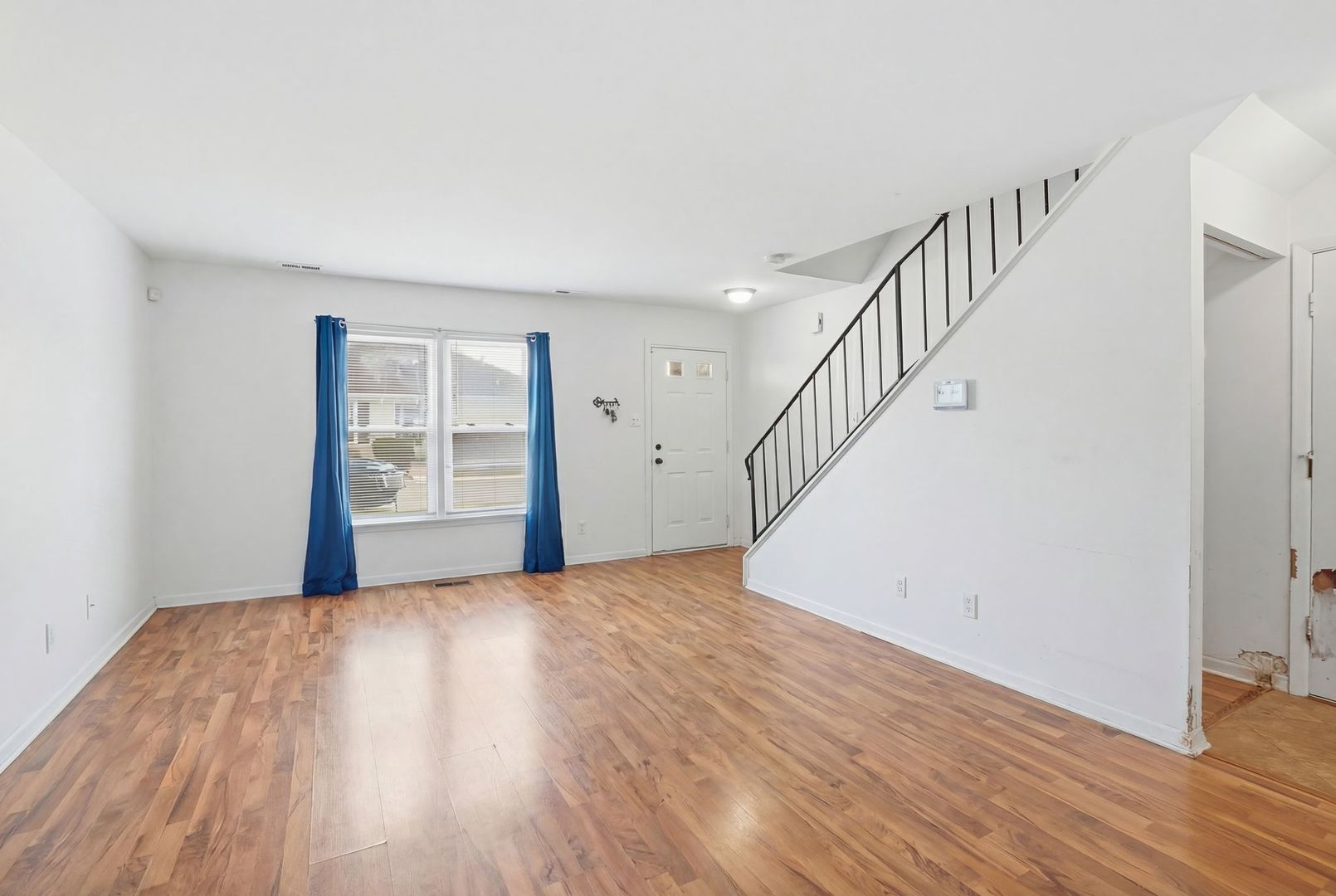 458 Wyeth Court Bolingbrook, IL 60440 - Photo 2 of 17 a view of an empty room with wooden floor and a window