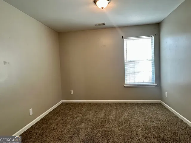 a kitchen with a stove top oven and refrigerator