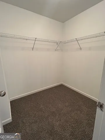 a view of a house with wooden fence