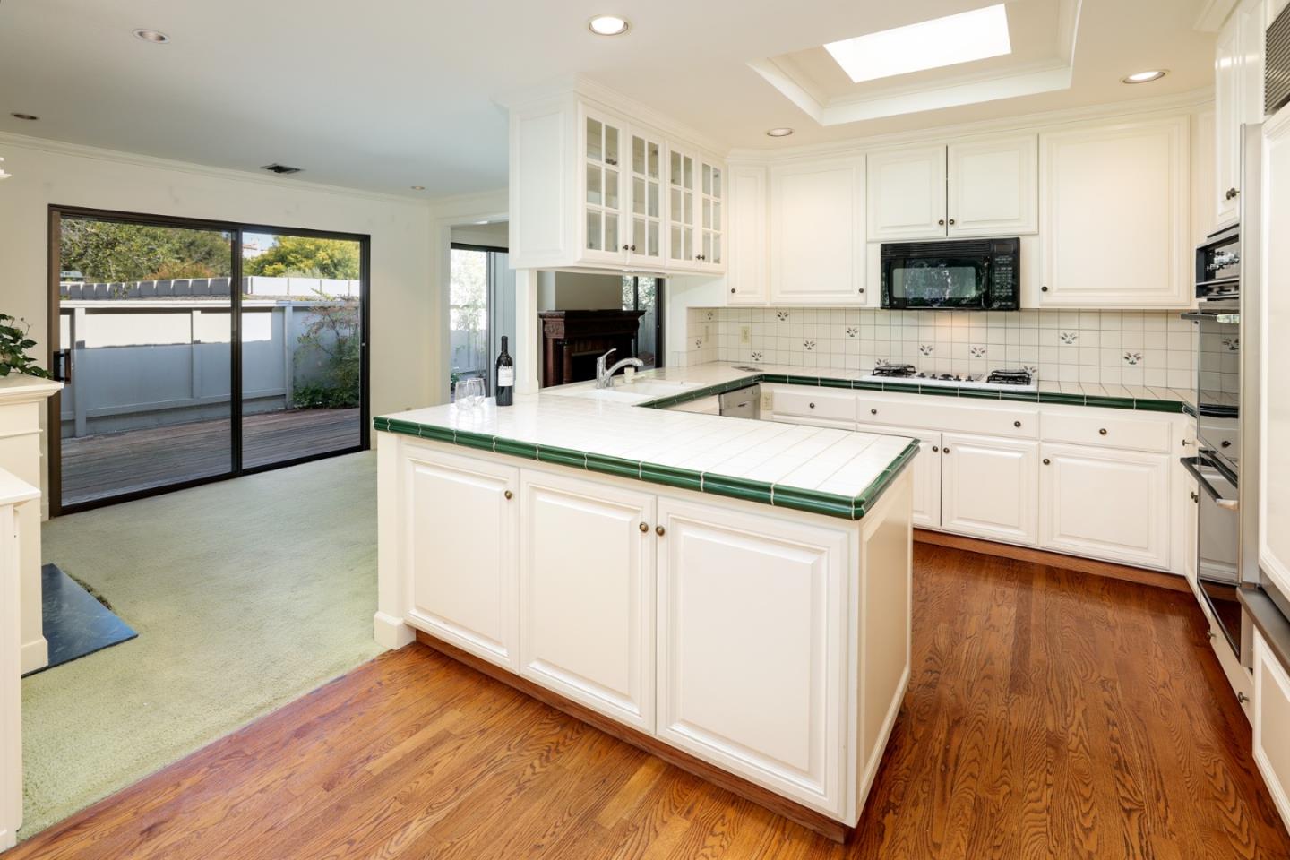 47 Bay Tree Lane Los Altos, CA 94022 - Photo 5 of 34 a kitchen with stainless steel appliances granite countertop a stove a sink and a microwave
