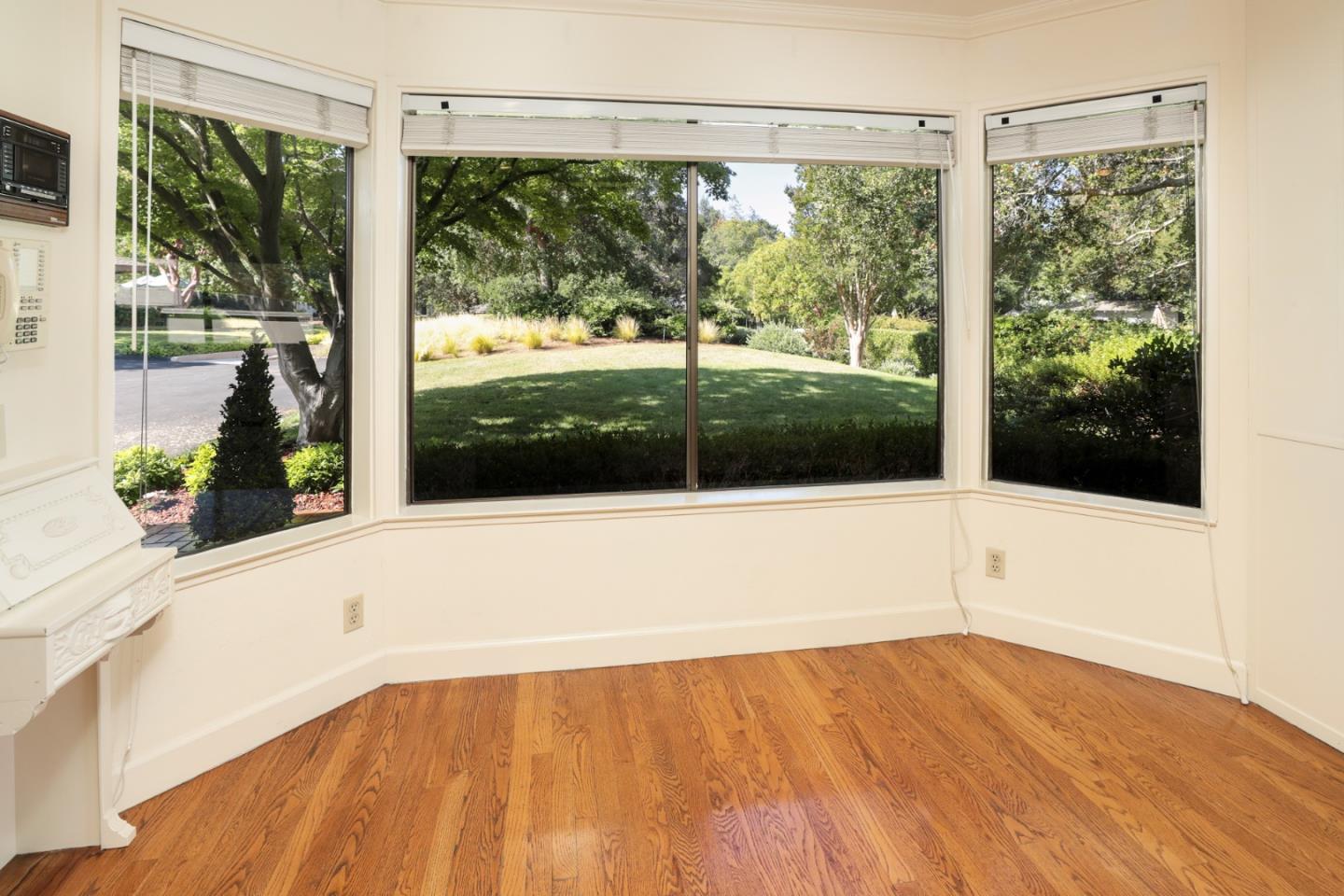 47 Bay Tree Lane Los Altos, CA 94022 - Photo 6 of 34 a view of an empty room with wooden floor and a window