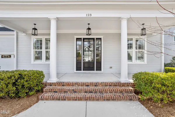 a front view of a house with a garden