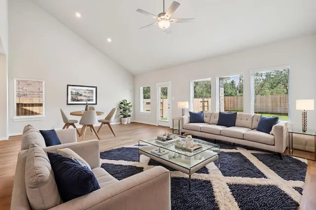 a living room with furniture and wooden floor