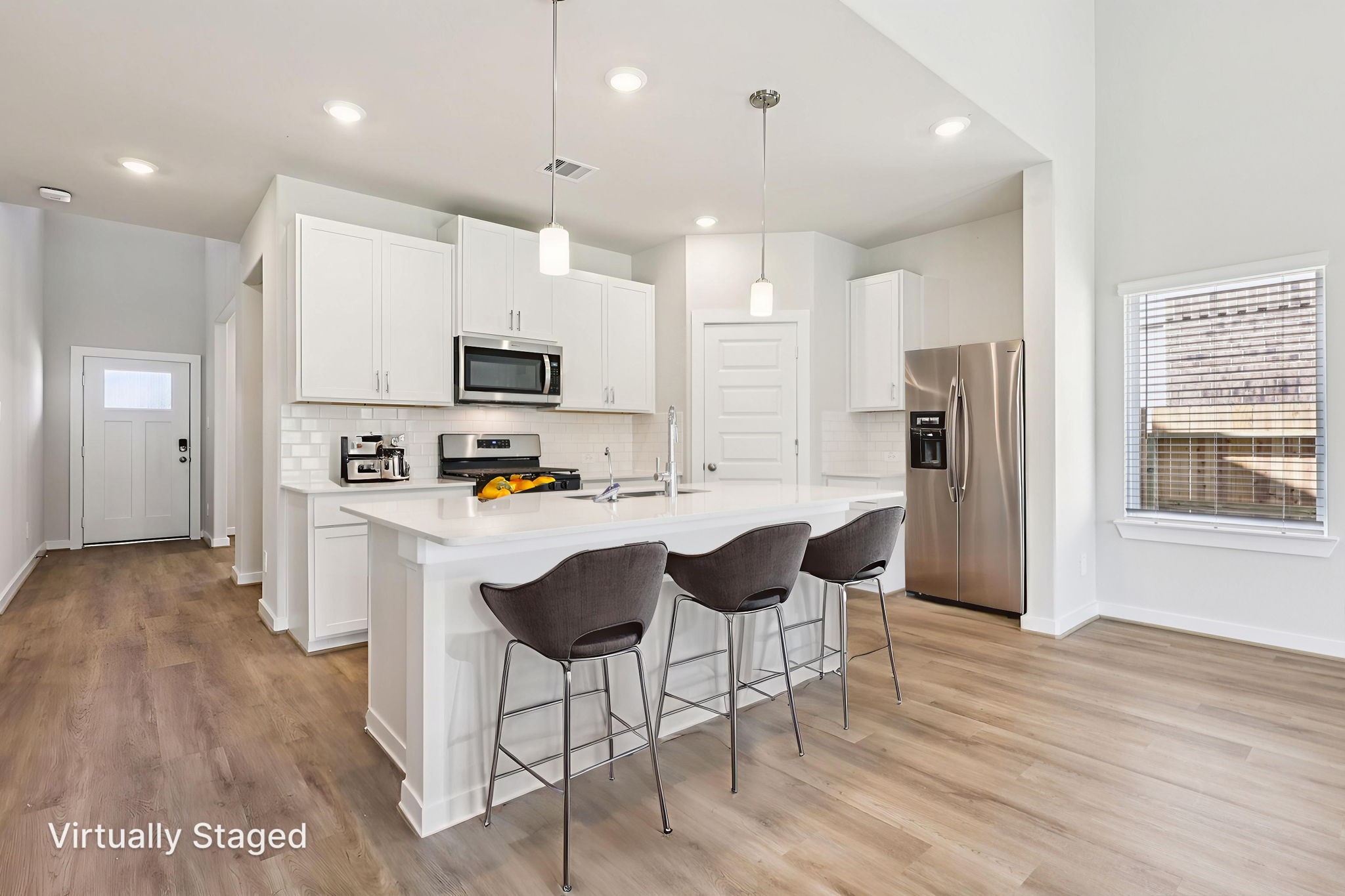 5223 Kingdom Heights Boulevard Rosenberg, TX 77471 - Photo 14 of 41 a kitchen with stainless steel appliances granite countertop a refrigerator a stove top oven a sink dishwasher and a refrigerator with wooden floor