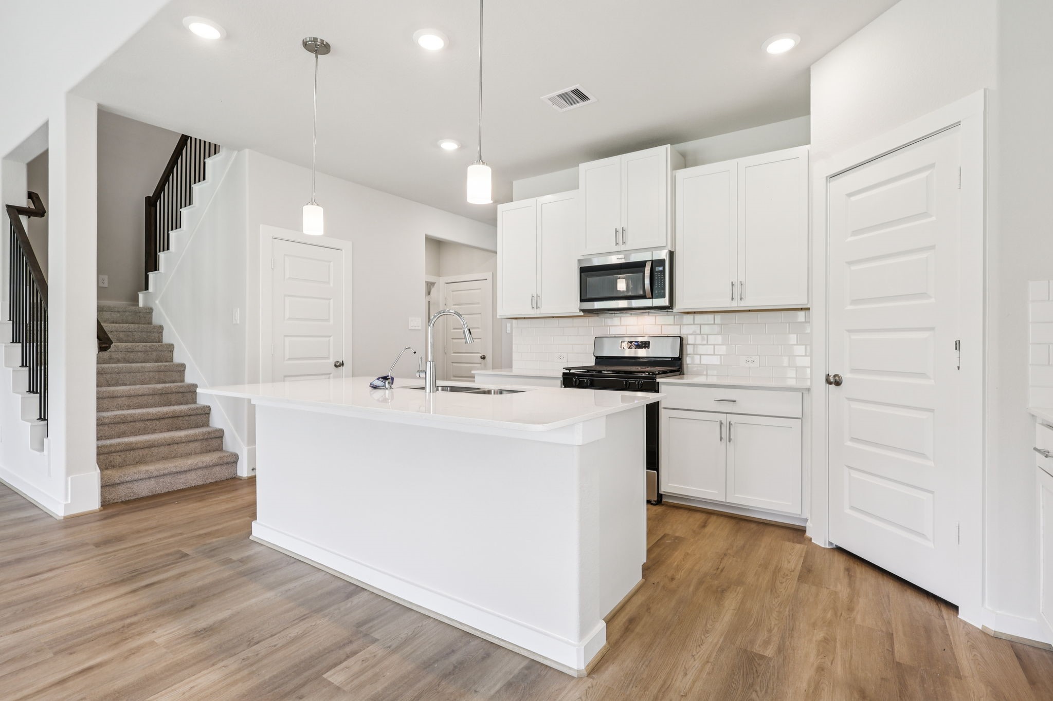 5223 Kingdom Heights Boulevard Rosenberg, TX 77471 - Photo 15 of 41 a kitchen with stainless steel appliances a refrigerator sink and white cabinets