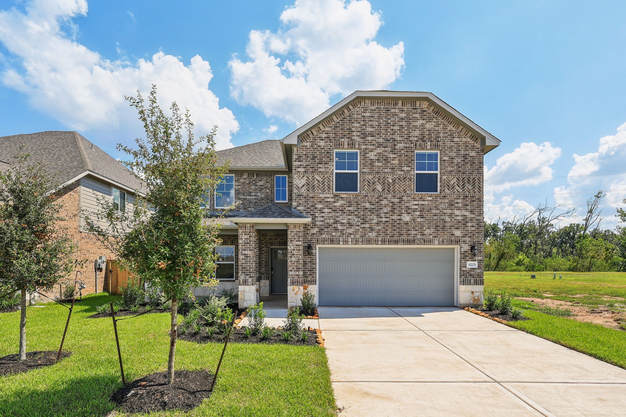 5223 Kingdom Heights Boulevard Rosenberg, TX 77471 - Photo 2 of 41 a front view of a house with a yard and garage