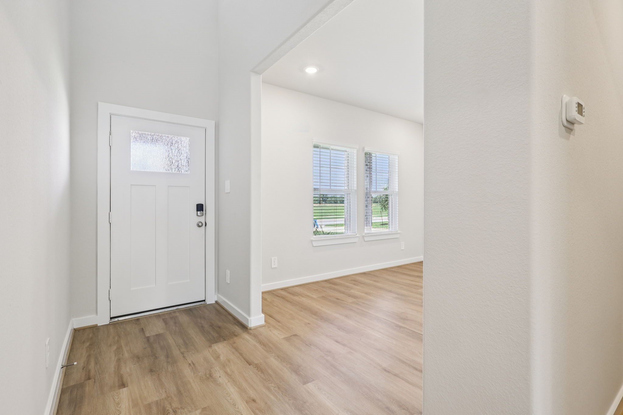 5223 Kingdom Heights Boulevard Rosenberg, TX 77471 - Photo 3 of 41 an empty room with wooden floor and windows