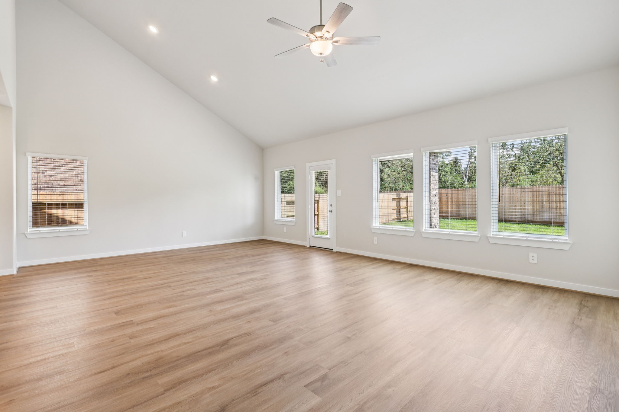 5223 Kingdom Heights Boulevard Rosenberg, TX 77471 - Photo 8 of 41 a view of an empty room with wooden floor and a window