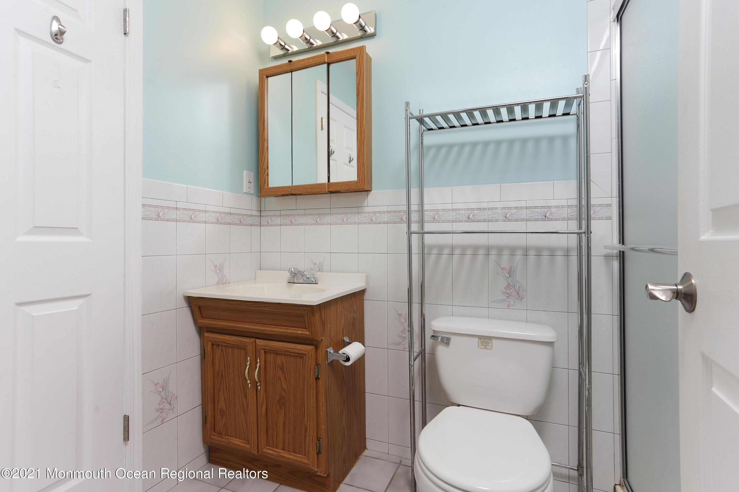 100 1st Street, Unit 11 Keyport, NJ 07735 - Photo 15 of 29 a bathroom with a toilet a sink and mirror