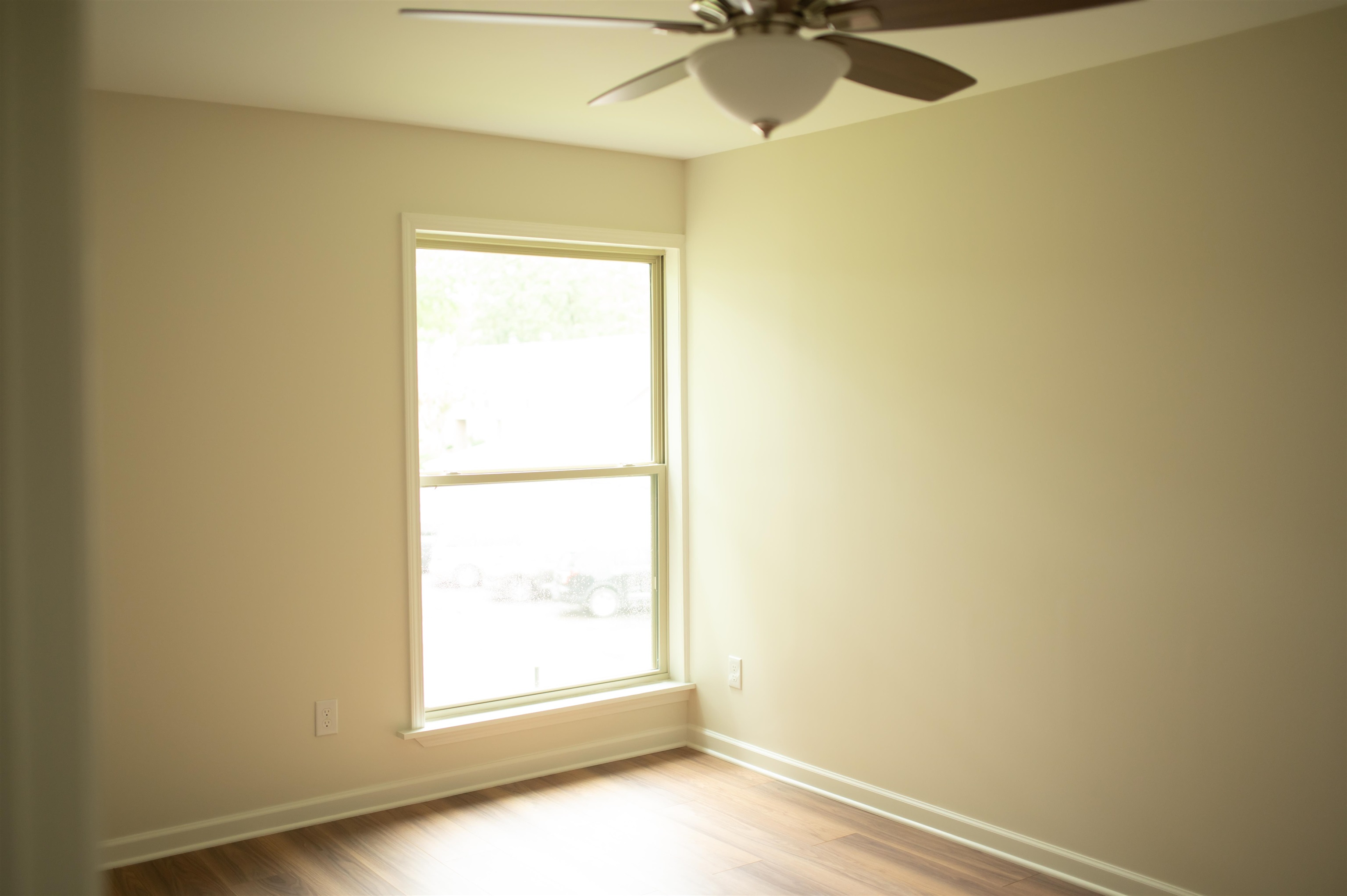3102 Rising Sun Road, Unit 59 Lakeland, TN 38002 - Photo 25 of 29 Unfurnished room with ceiling fan, a wealth of natural light, and hardwood / wood-style flooring