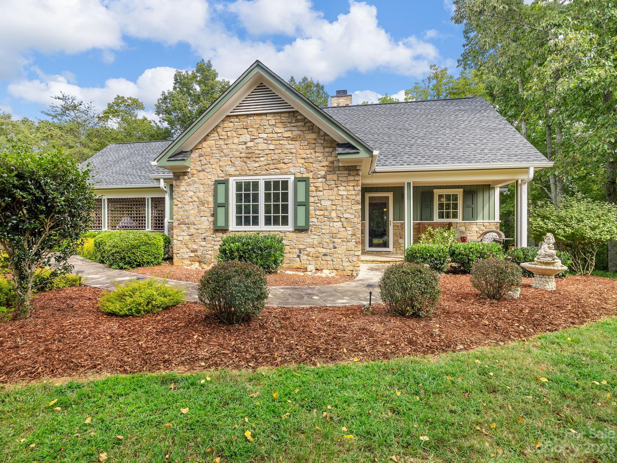 795 Golden Road Tryon, NC 28782 - Photo 1 of 32 a view of a house with a yard and potted plants
