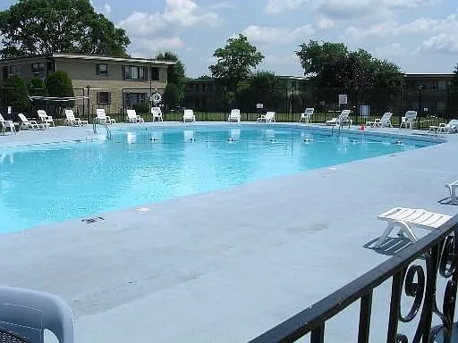 an aerial view of a swimming pool with seating space