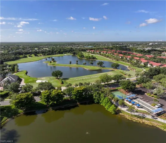 an aerial view of residential houses with outdoor space and lake view