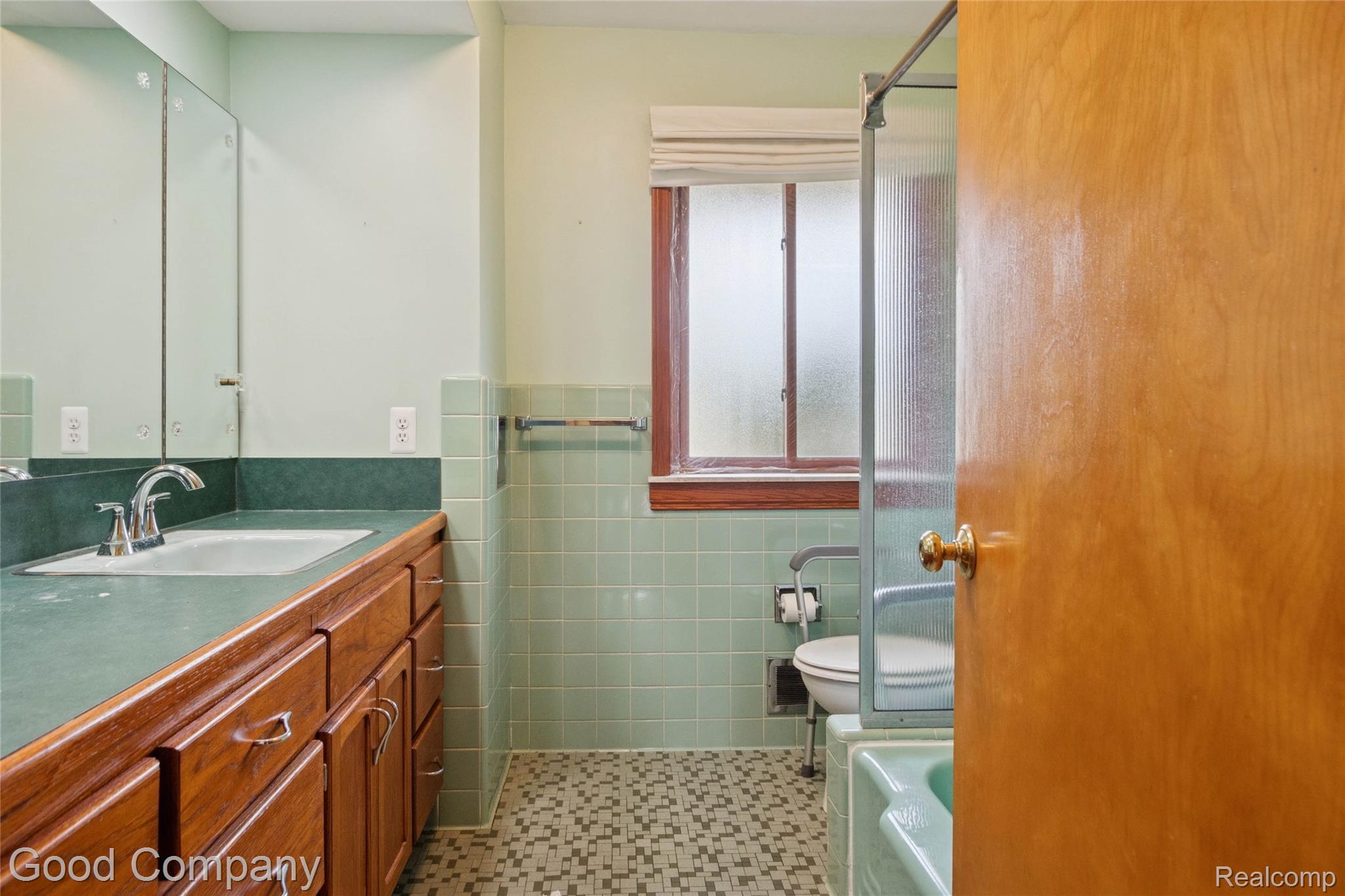 33920 Mulvey Road Fraser, MI 48026 - Photo 21 of 49 Full bathroom featuring vanity, tile walls, a tub to relax in, a shower, and a wainscoted wall