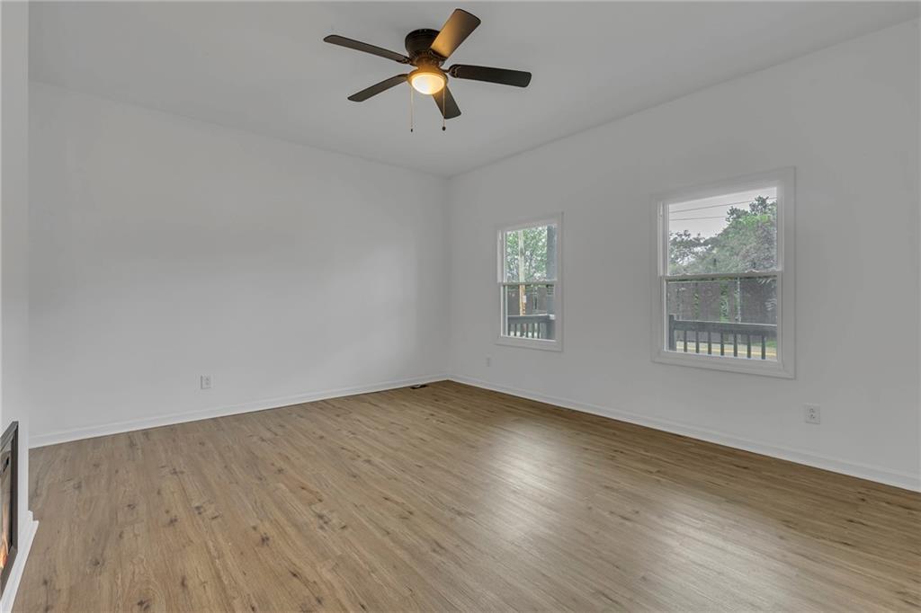 193 Virginia Avenue Rochester, PA 15074 - Photo 5 of 37 an empty room with wooden floor ceiling fan and windows
