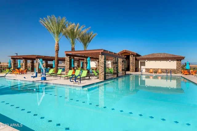 a view of house with swimming pool yard and outdoor seating