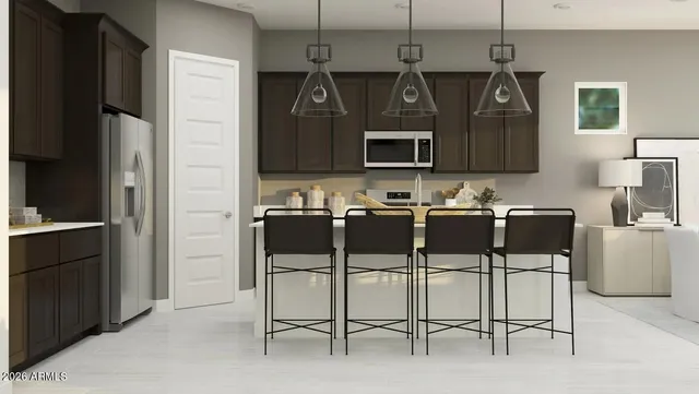 a kitchen with a refrigerator and microwave