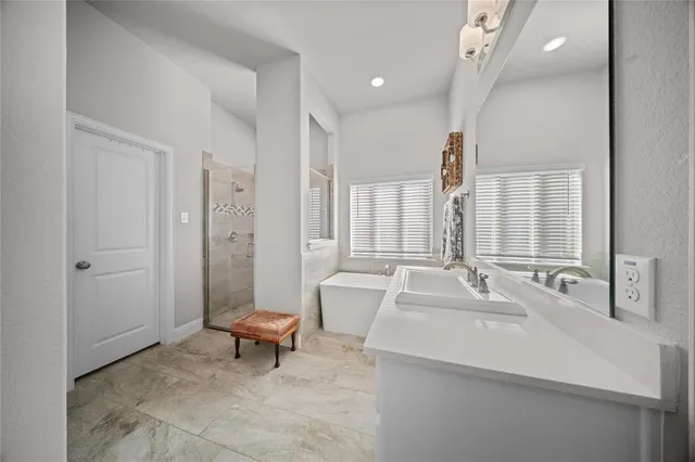 a bathroom with a sink a toilet and a large mirror