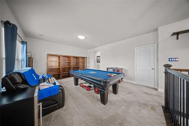 a living room with furniture a air conditioner vent and a window