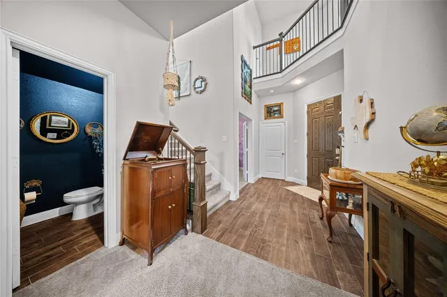 a bedroom with a bed and a lamp on dresser