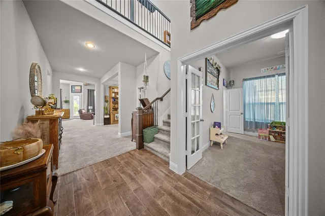a view of a livingroom with furniture and staircase