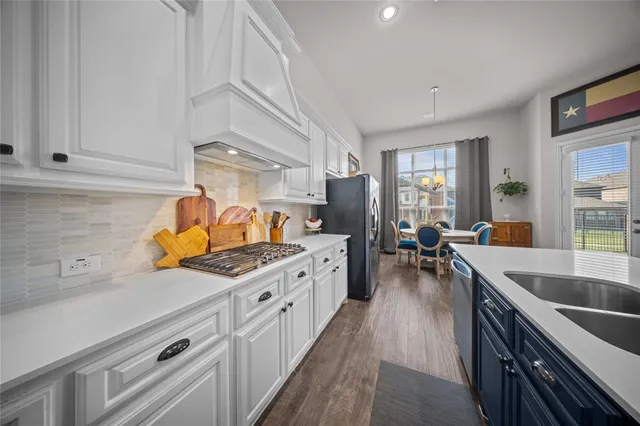 a kitchen with stove cabinets and living room view