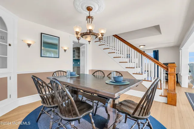 a kitchen with kitchen island a stove a refrigerator and wooden floor