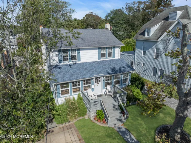 a aerial view of a house next to a yard