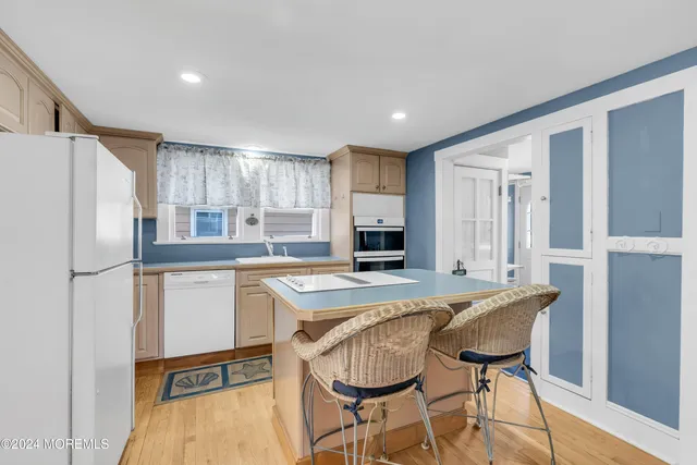 a kitchen with a table chairs refrigerator and cabinets