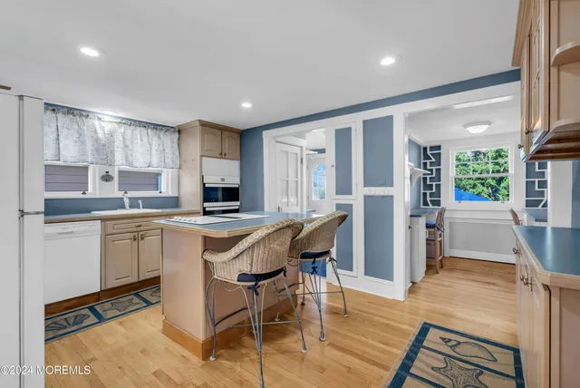 a kitchen that has a cabinets a refrigerator and a stove