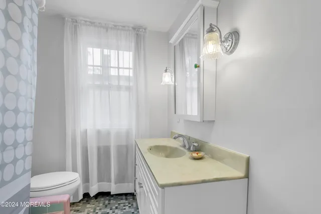 a bathroom with a toilet and a shower curtain