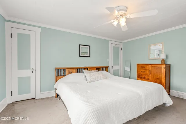 a bedroom with a bed and a dresser in it