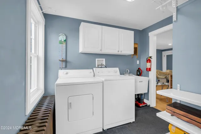 an aerial view of a house with a yard and a large tree