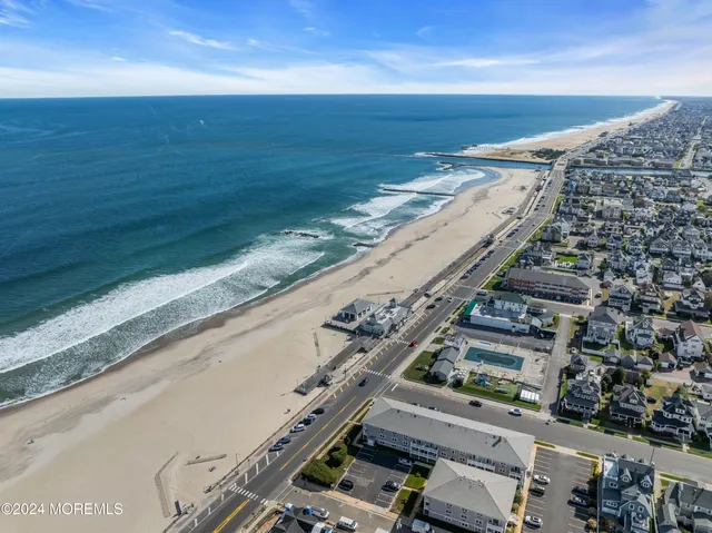 a lawn chair sitting under a blue umbrella