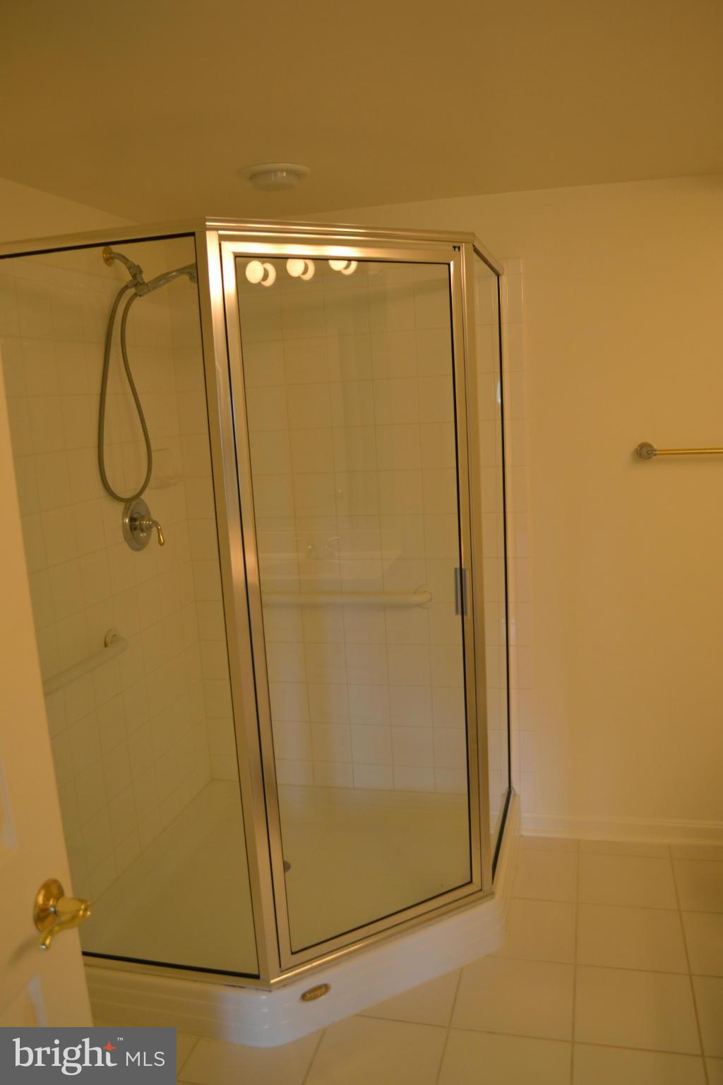 12246 Roundwood Road, Unit 405 Lutherville-Timonium, MD 21093 - Photo 13 of 16 a bathroom with a glass shower door