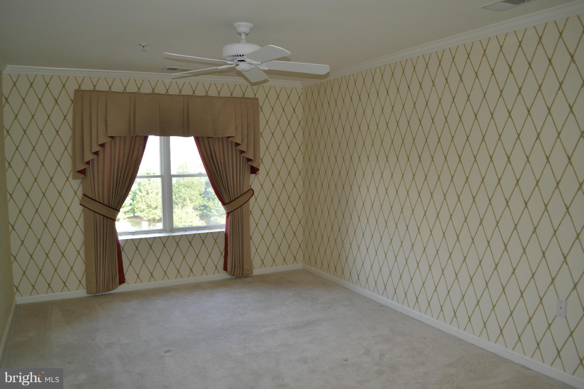 12246 Roundwood Road, Unit 405 Lutherville-Timonium, MD 21093 - Photo 15 of 16 wooden floor in an empty room with a window