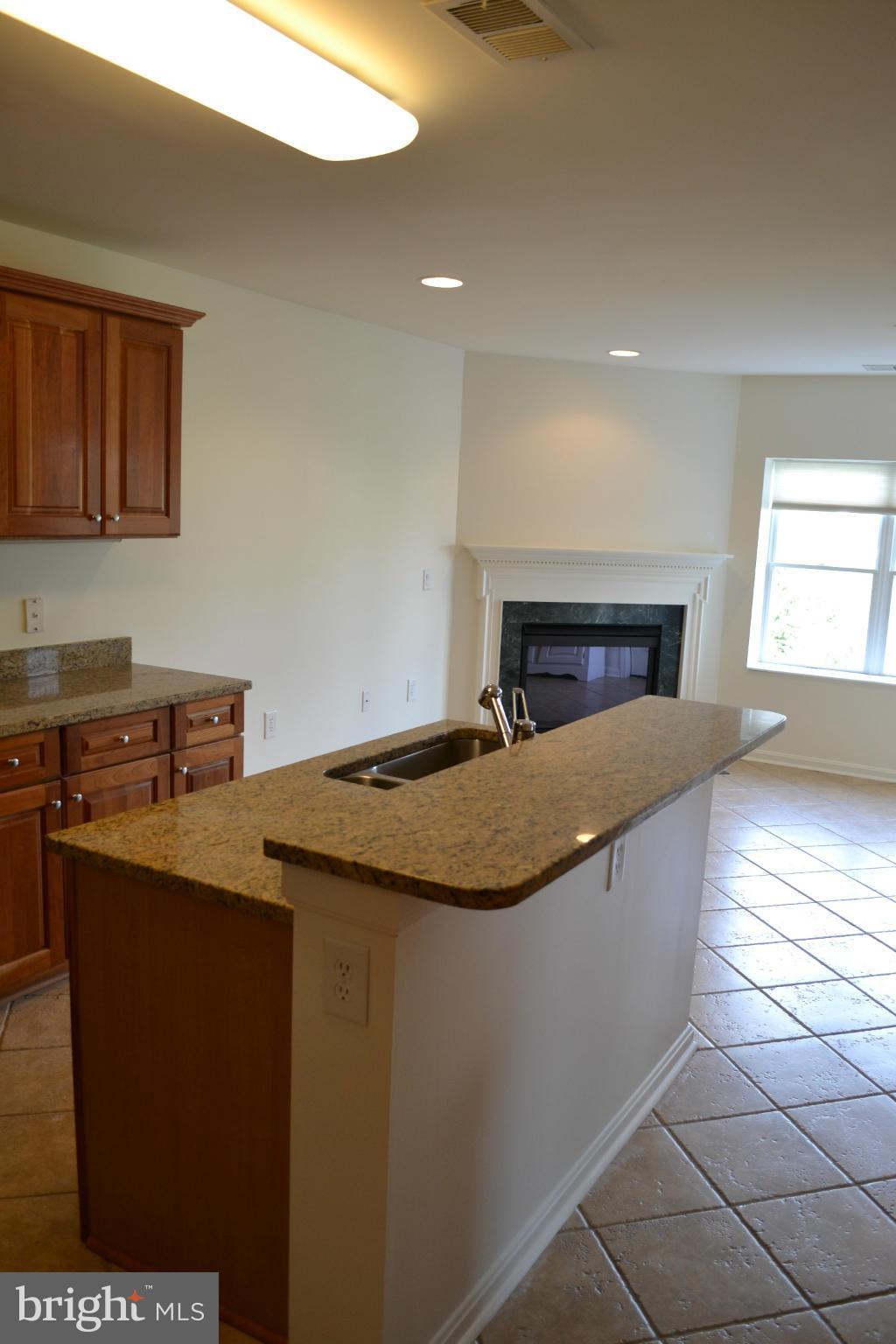 12246 Roundwood Road, Unit 405 Lutherville-Timonium, MD 21093 - Photo 6 of 16 a kitchen with stainless steel appliances granite countertop a sink a stove and a refrigerator