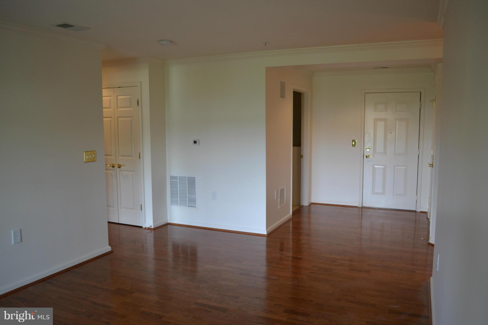 12246 Roundwood Road, Unit 405 Lutherville-Timonium, MD 21093 - Photo 9 of 16 a view of an empty room with wooden floor