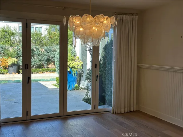 a view of a room with balcony and wooden floor