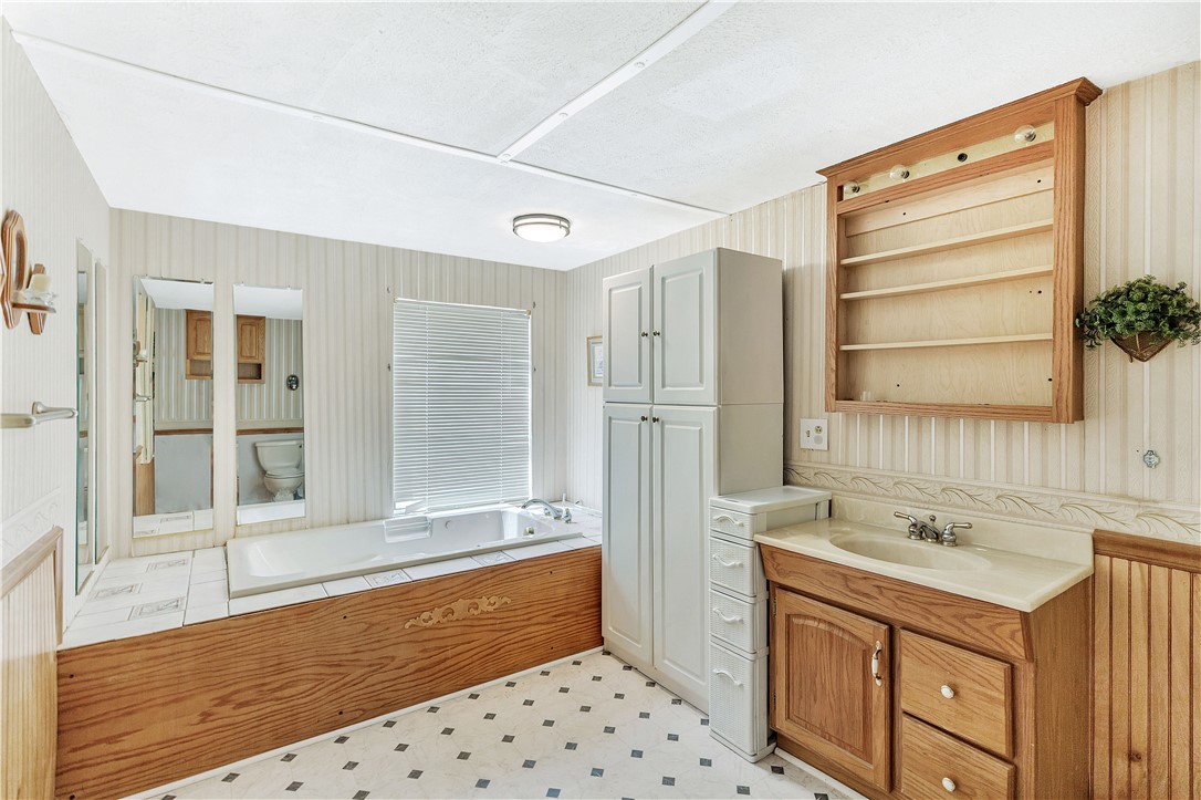 1004 Wiles Road Anderson, SC 29625 - Photo 19 of 26 A well-equipped primary bathroom features a generous soaking tub and practical vanity storage.