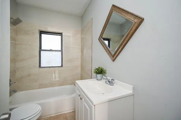 a bathroom with a sink toilet and tub