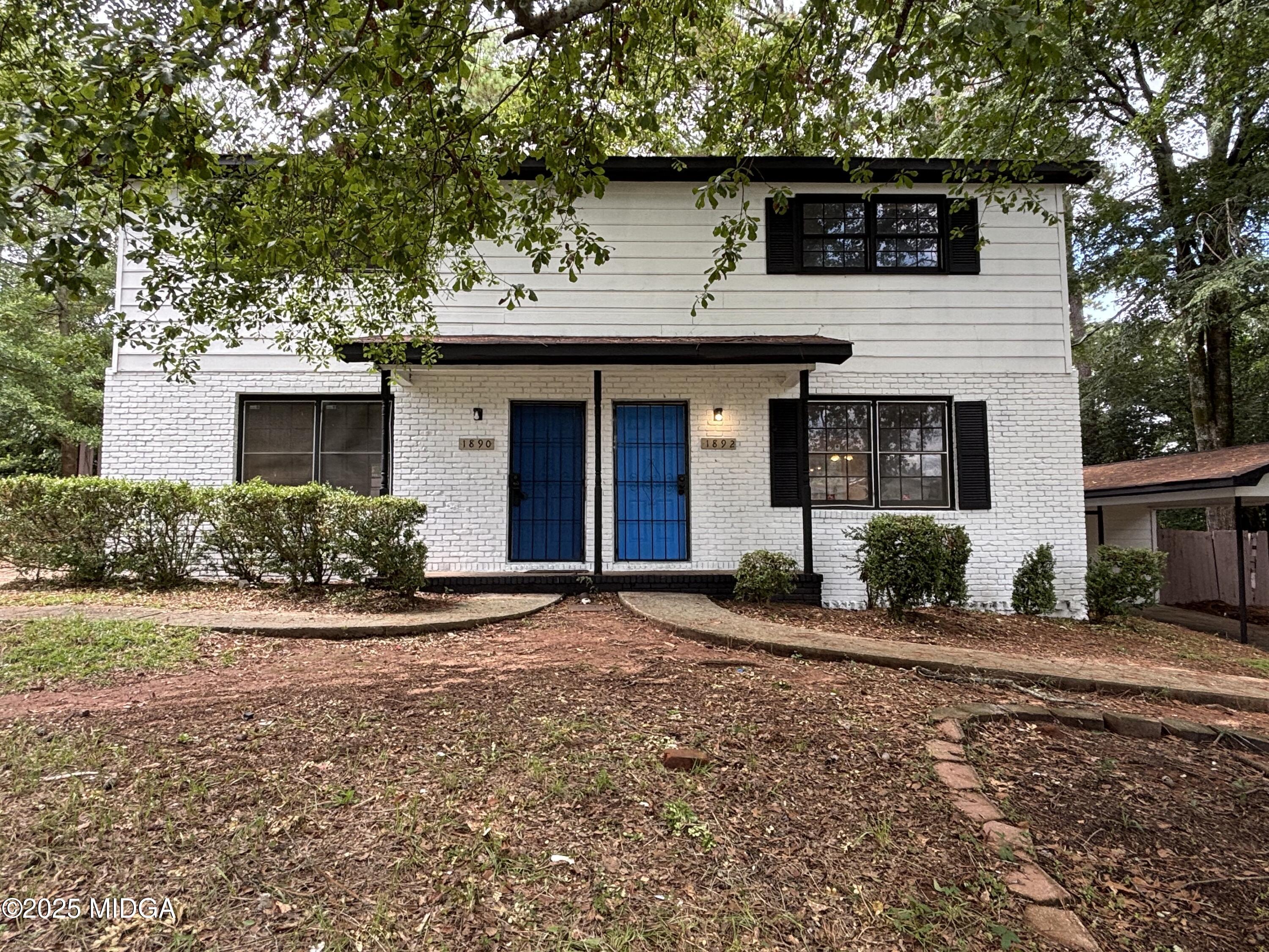 1890-1892 Clinton Road Macon, GA 31211 - Photo 1 of 19 a front view of a house with a yard